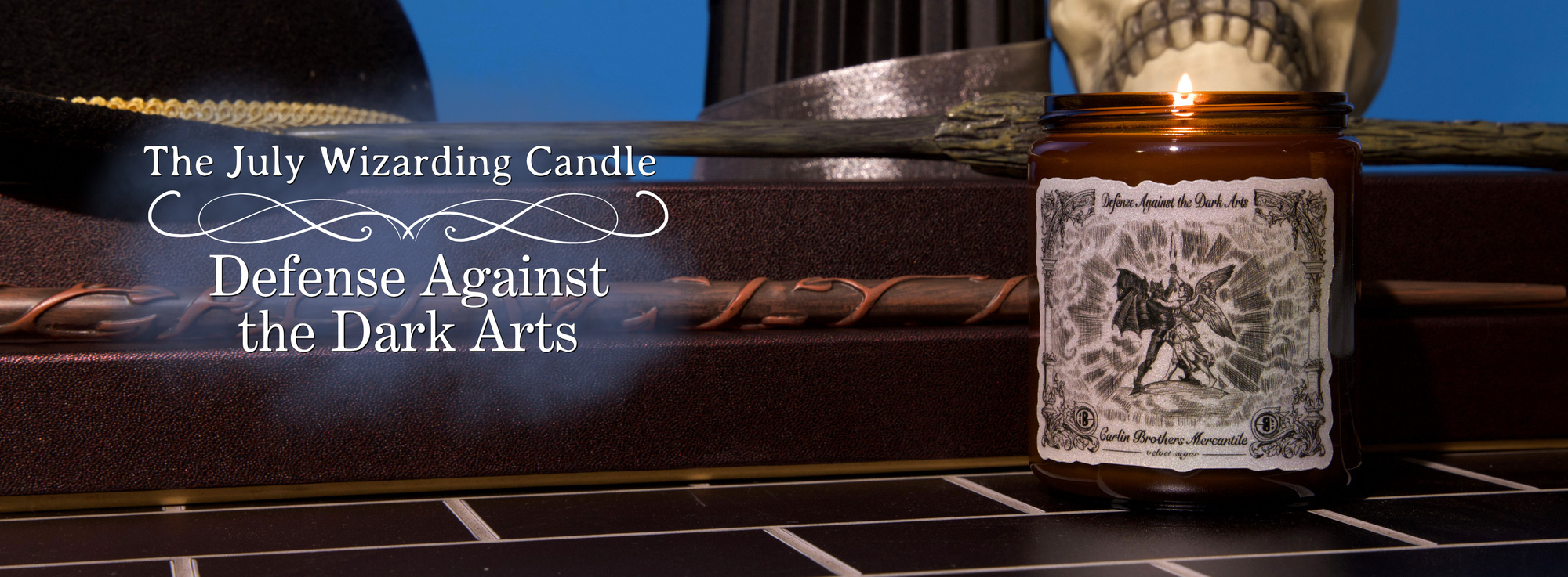 The July Wizarding Candle - Defense Against The Dark Arts. Candle is placed on black tile with a blue background surrounded by wands and wizard classroom decor