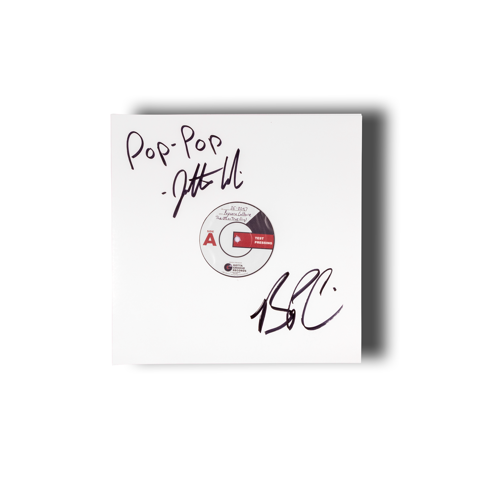 White album cover with black text and a red label on a white background