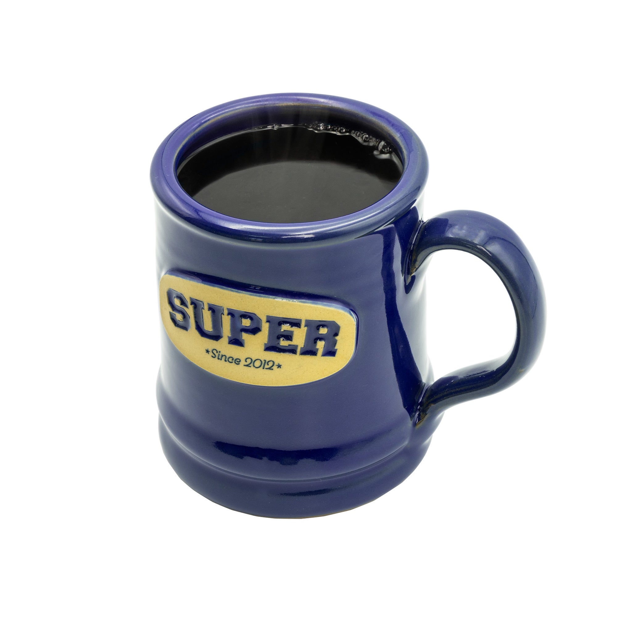 blue deneen mug with super *since 2012* emblem with coffee