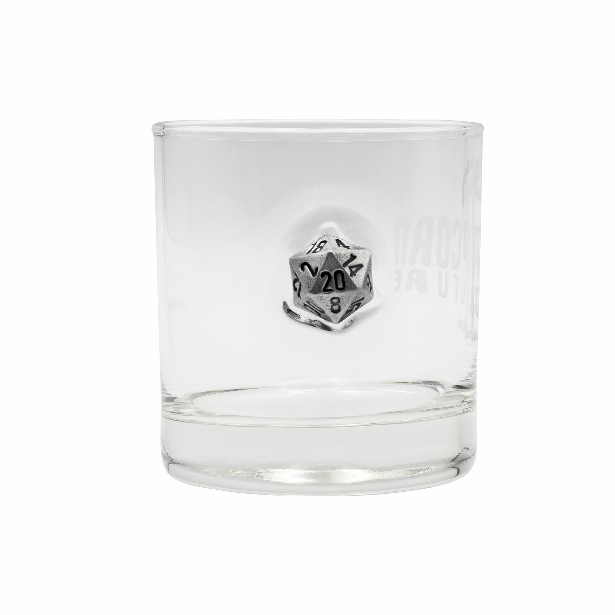 Clear glass tumbler with a metal dice emblem on a white background